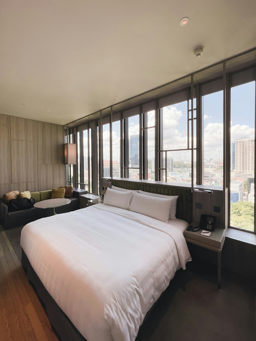 white bed linen near glass window