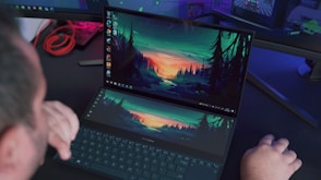 black laptop computer turned on displaying green and yellow lights