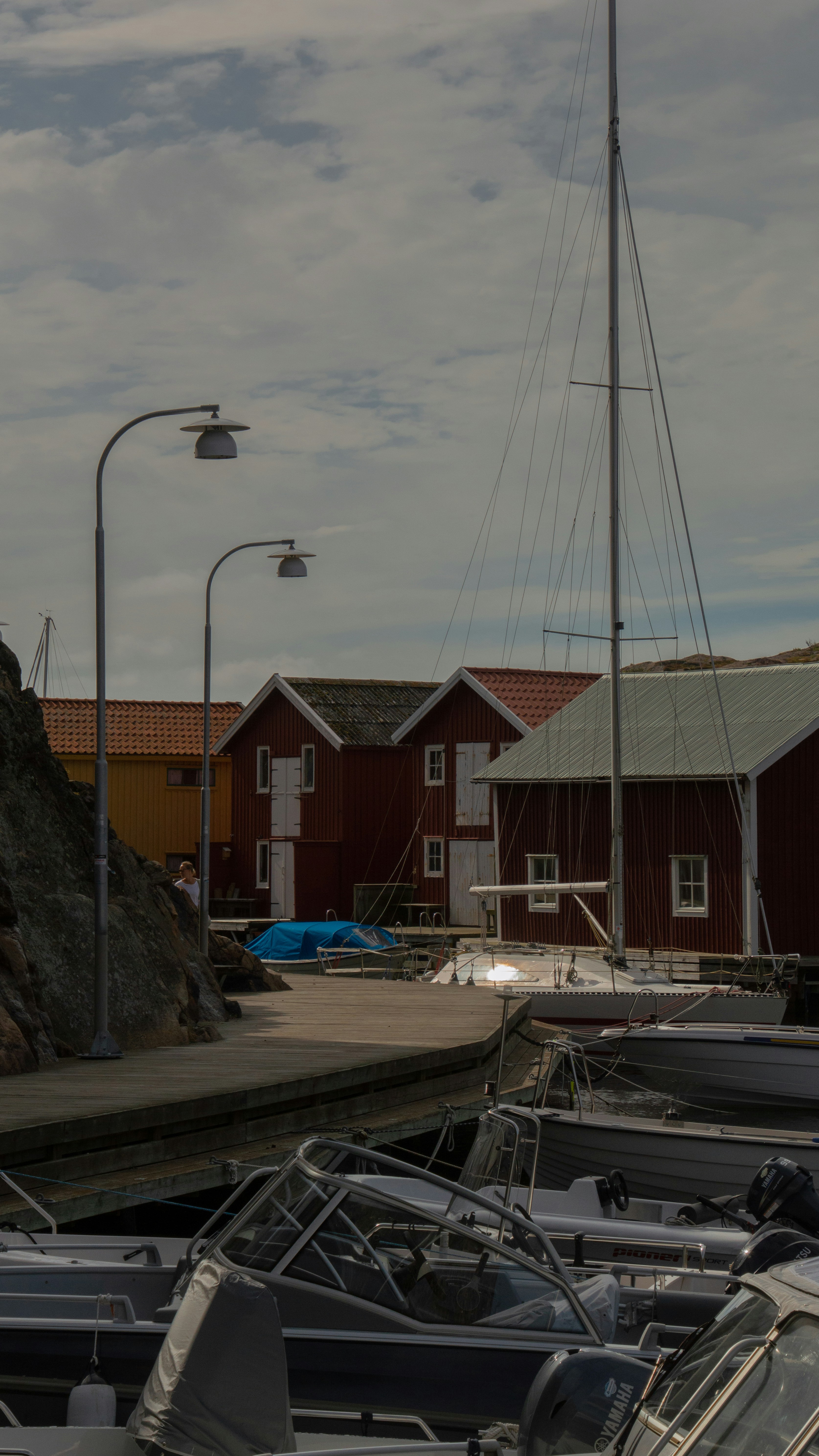 white and blue boat on dock near brown concrete building during daytime