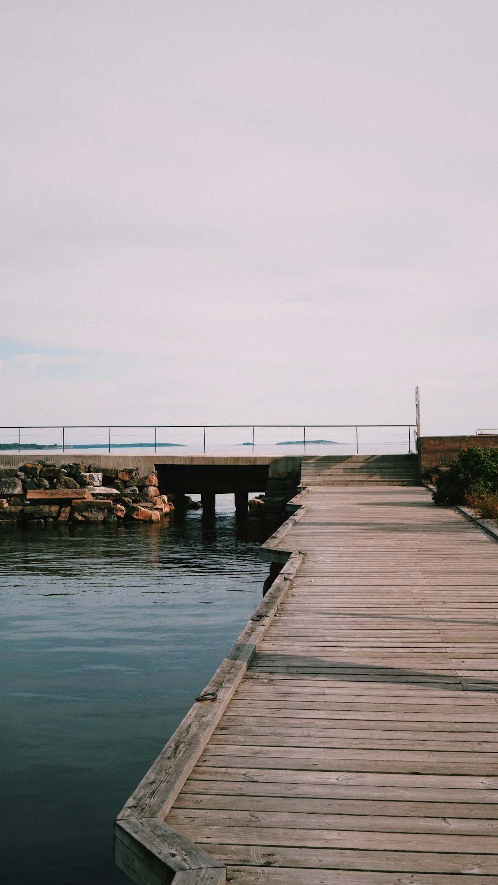 brown wooden dock on body of water during daytime