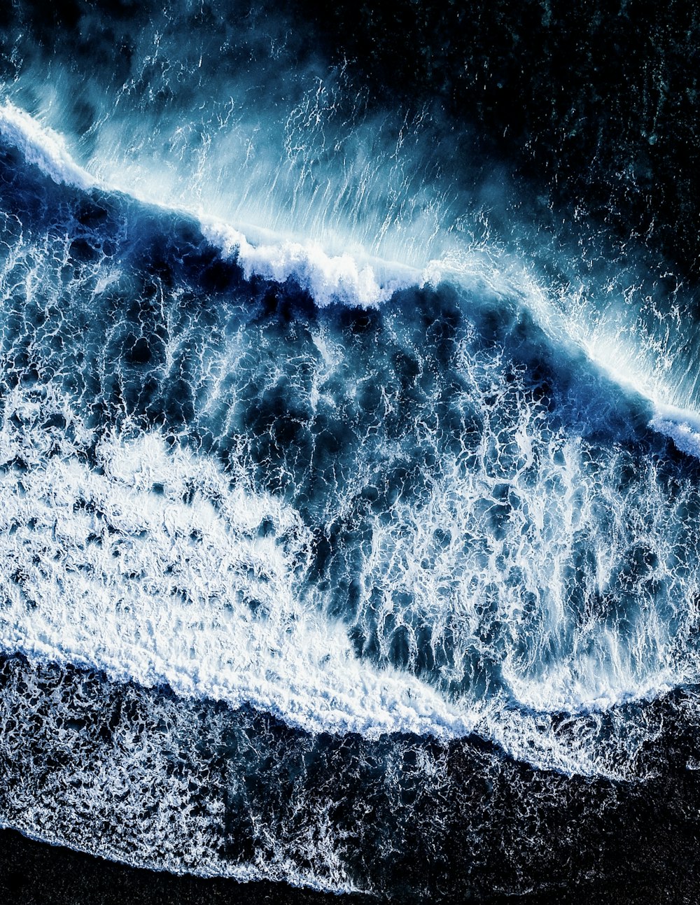 water splash on brown and black sand