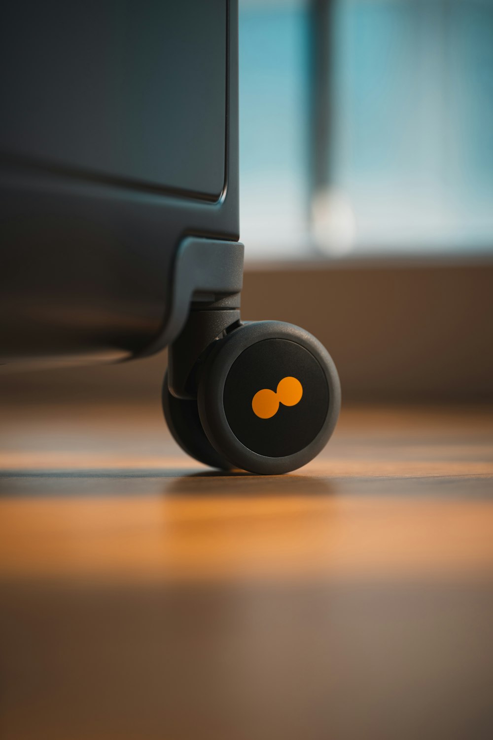 a close up of a black suitcase on a wooden floor