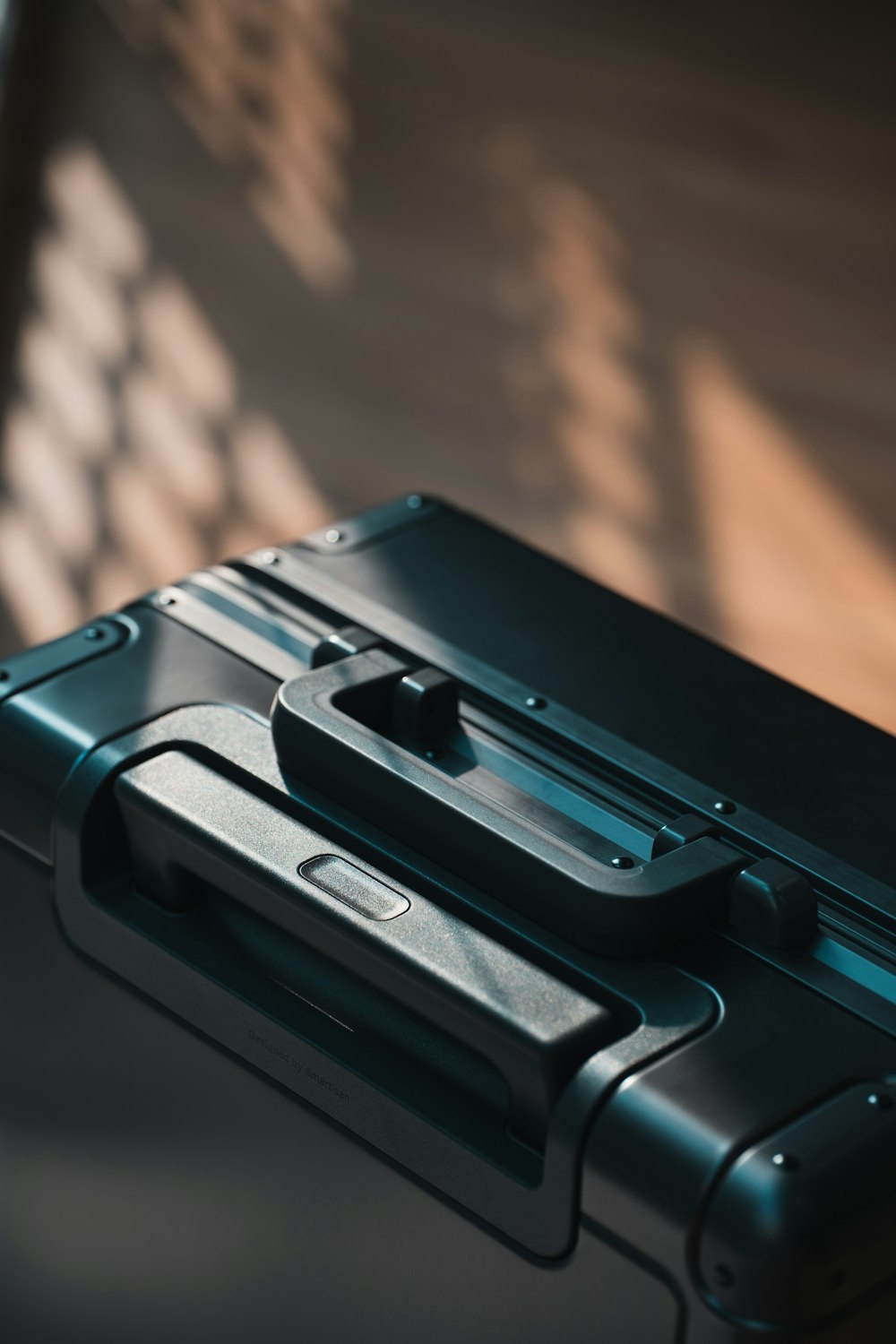 a black piece of luggage sitting on top of a wooden floor