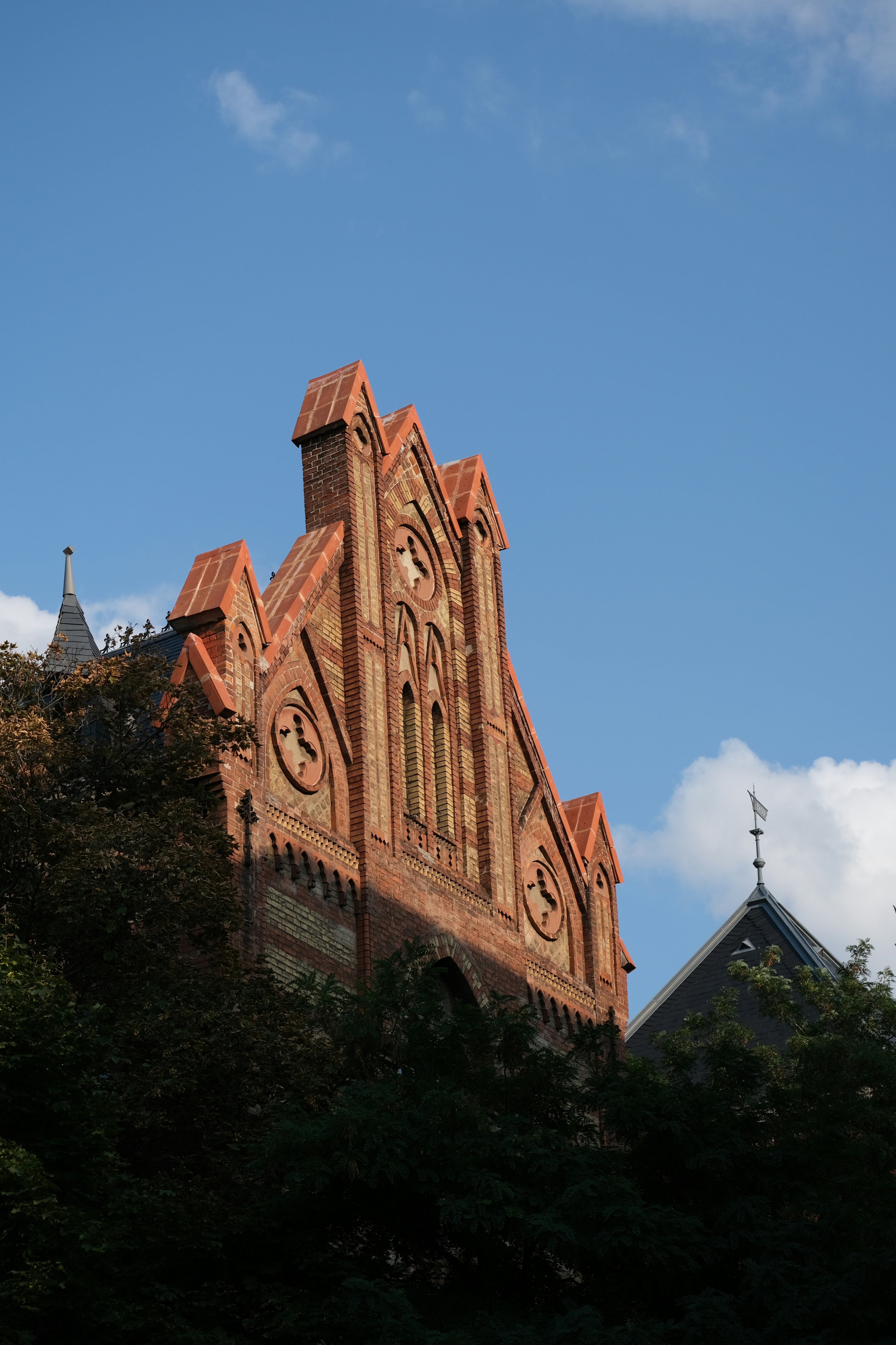 brown concrete building near green trees during daytime
