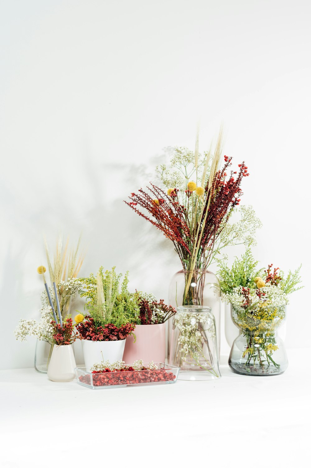 yellow and red flowers in clear glass vase