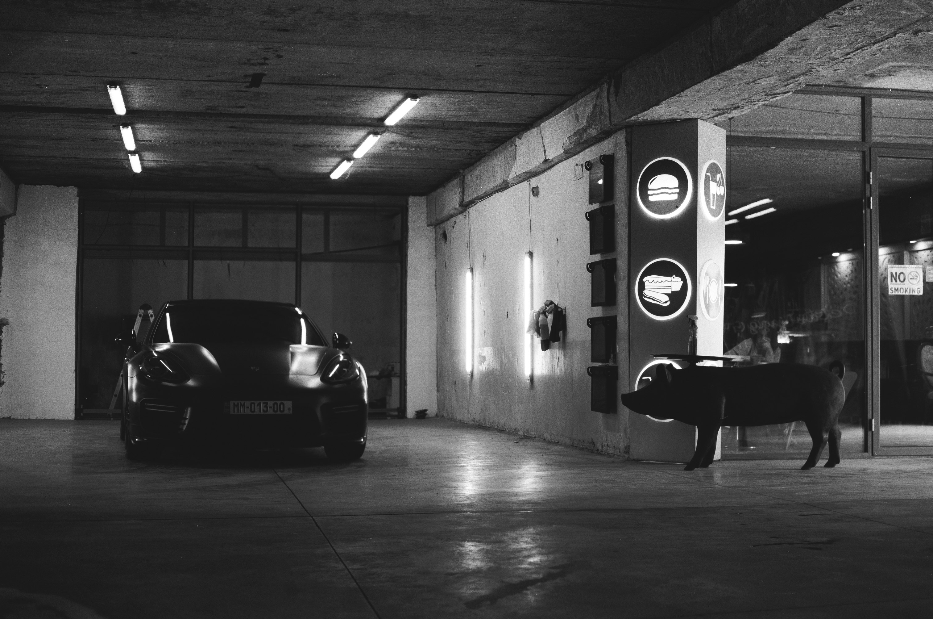 grayscale photo of car parked in tunnel
