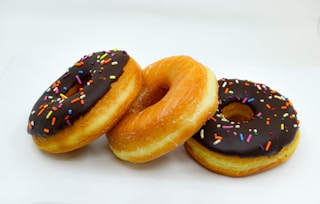 brown donuts with white cream on top