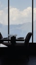 A beautifully set dining table with gourmet plates and a view of the golf landscape.
