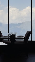 A beautifully set dining table with gourmet plates and a view of the golf landscape.