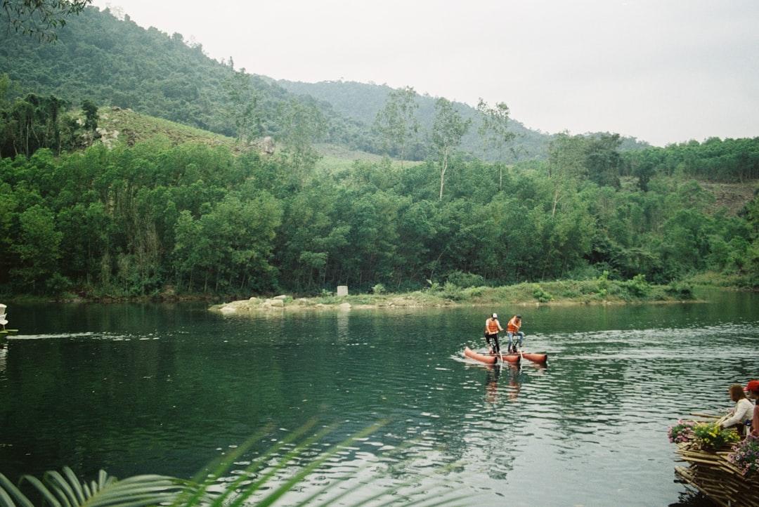 person riding on kayak on lake during daytime