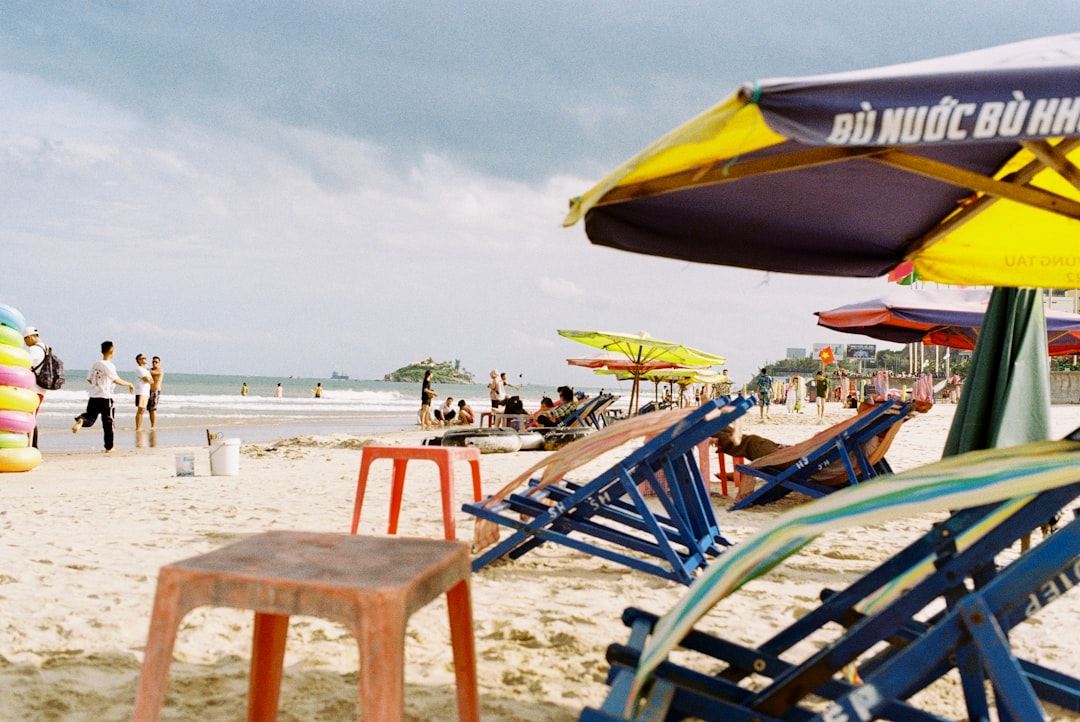 blue and yellow wooden chairs on beach during daytime