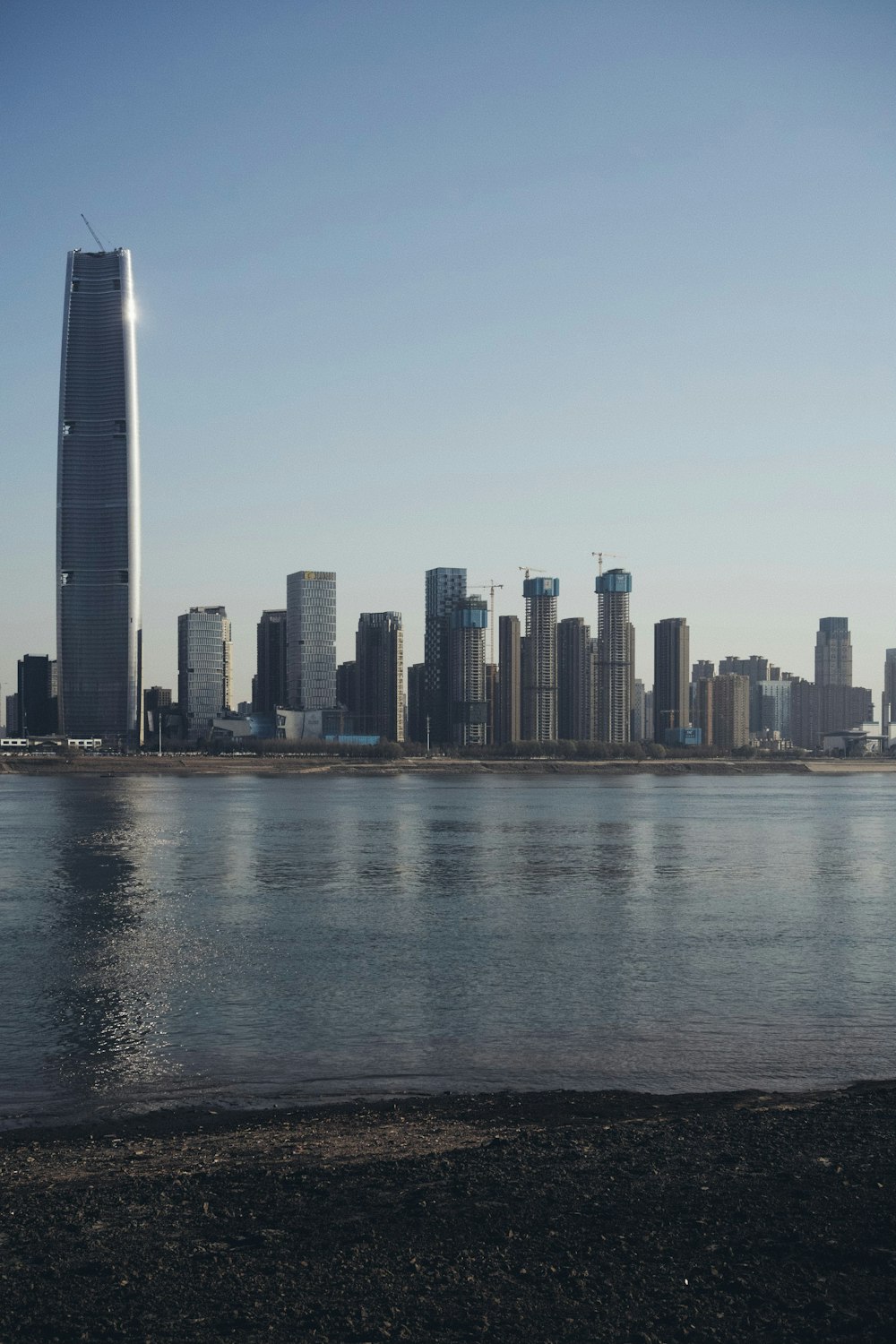 city skyline across body of water during daytime