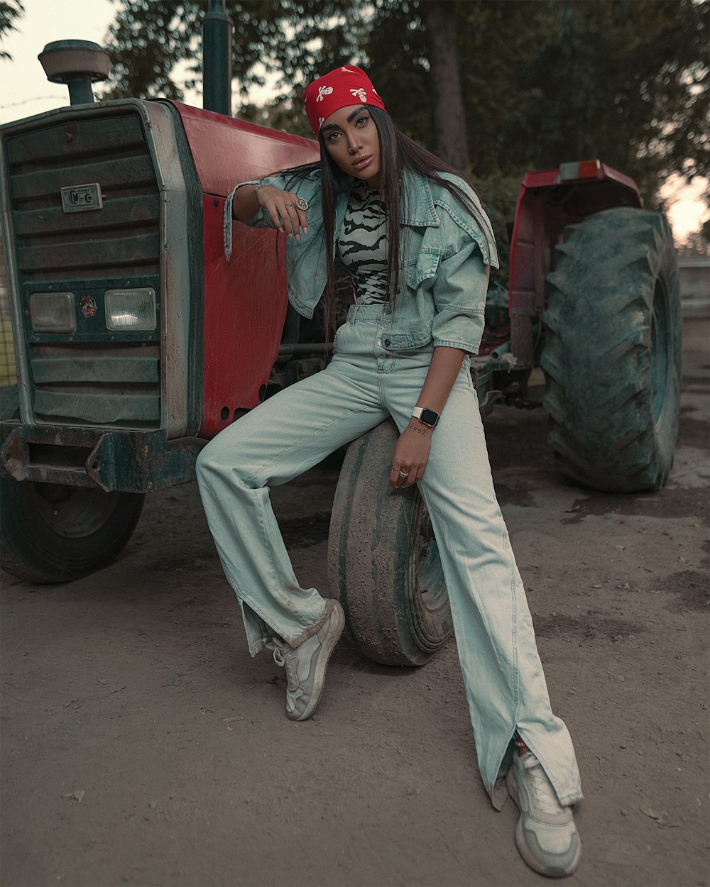 woman in gray jacket and pants sitting on red truck