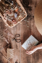 person holding white and red greeting card