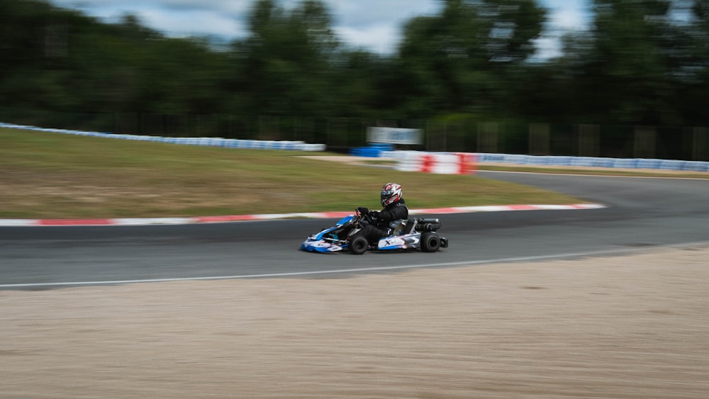 black and blue go kart on track during daytime