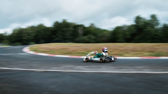 man riding green and black sports car on road during daytime
