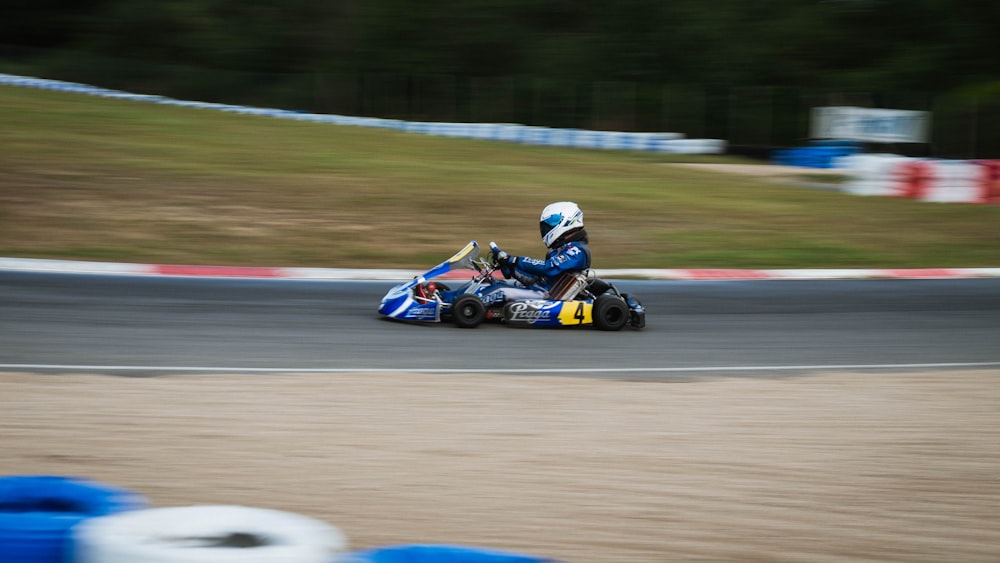 man riding on blue and black go kart
