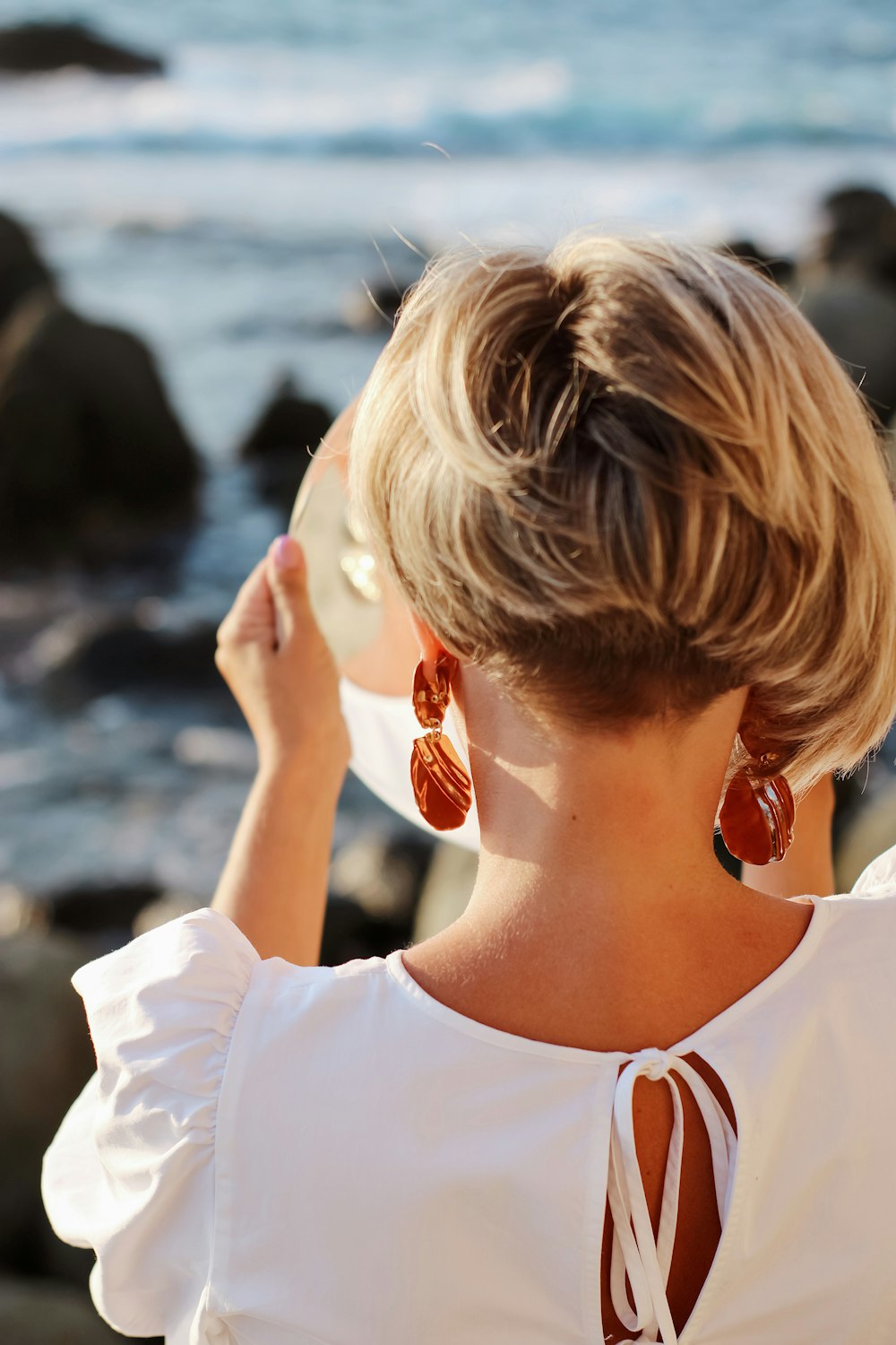 woman in white crew neck shirt wearing red sunglasses