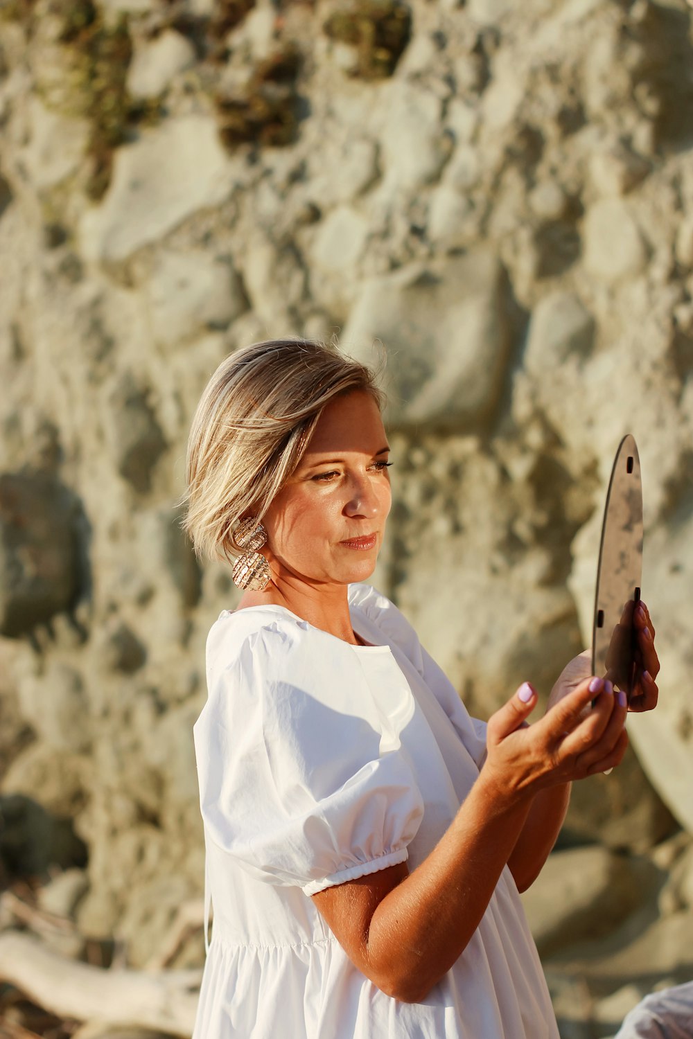 woman in white button up shirt holding knife