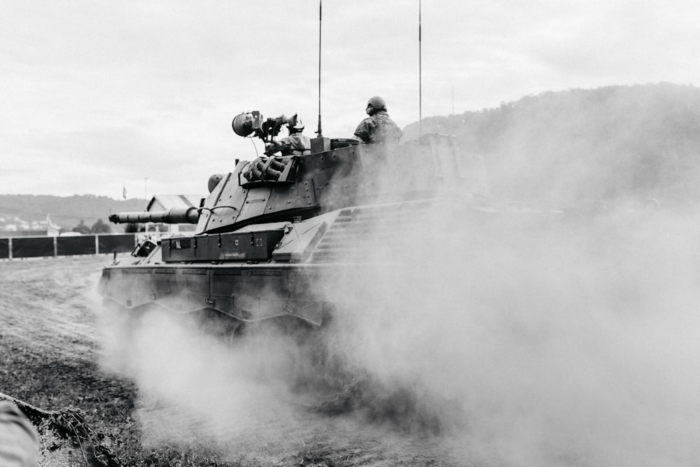 grayscale photo of soldiers on battle tank