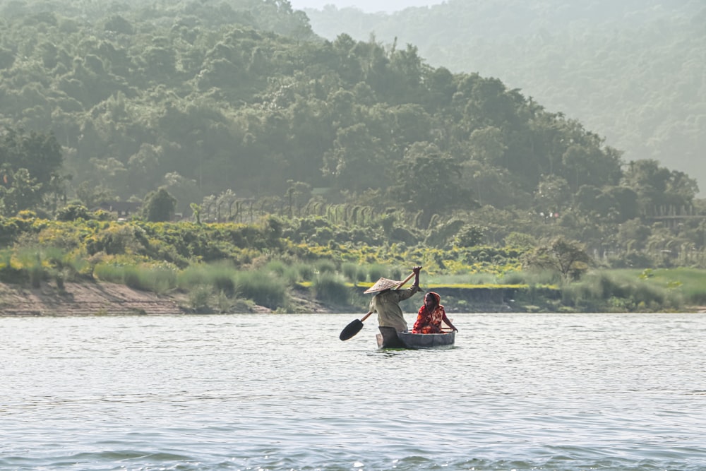 man in red shirt riding on boat during daytime