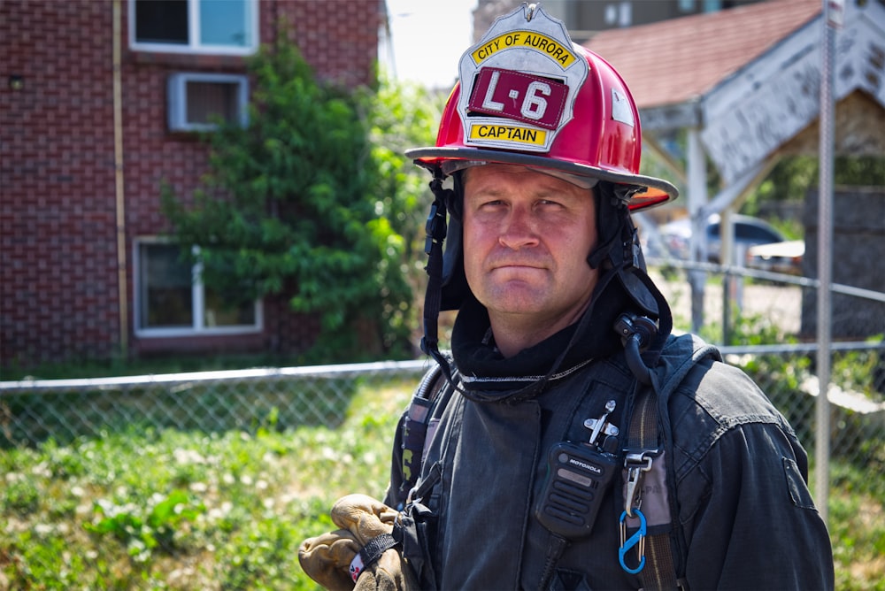 man in black jacket wearing red helmet