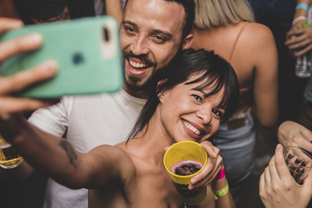 man and woman holding yellow ceramic mug