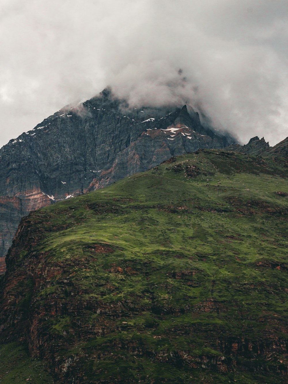 a very tall mountain with a very cloudy sky