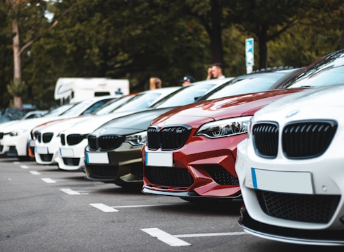 white and red bmw m 3 on road during daytime