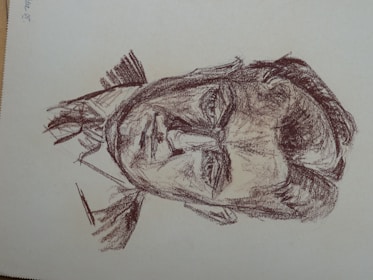 A sketch of a man drawn with rough, dark lines. The image focuses on detailed facial features, including deep-set eyes and a stern expression. The drawing style is reminiscent of classic charcoal or pencil sketches, with a textured and slightly chaotic appearance.