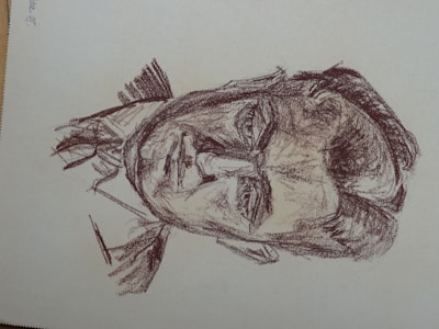 A sketch of a man drawn with rough, dark lines. The image focuses on detailed facial features, including deep-set eyes and a stern expression. The drawing style is reminiscent of classic charcoal or pencil sketches, with a textured and slightly chaotic appearance.