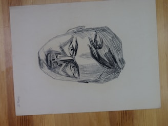 A contemplative pencil drawing showing layered emotions on a human face.