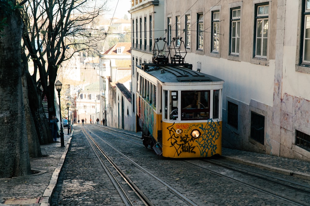 yellow and white tram on road during daytime