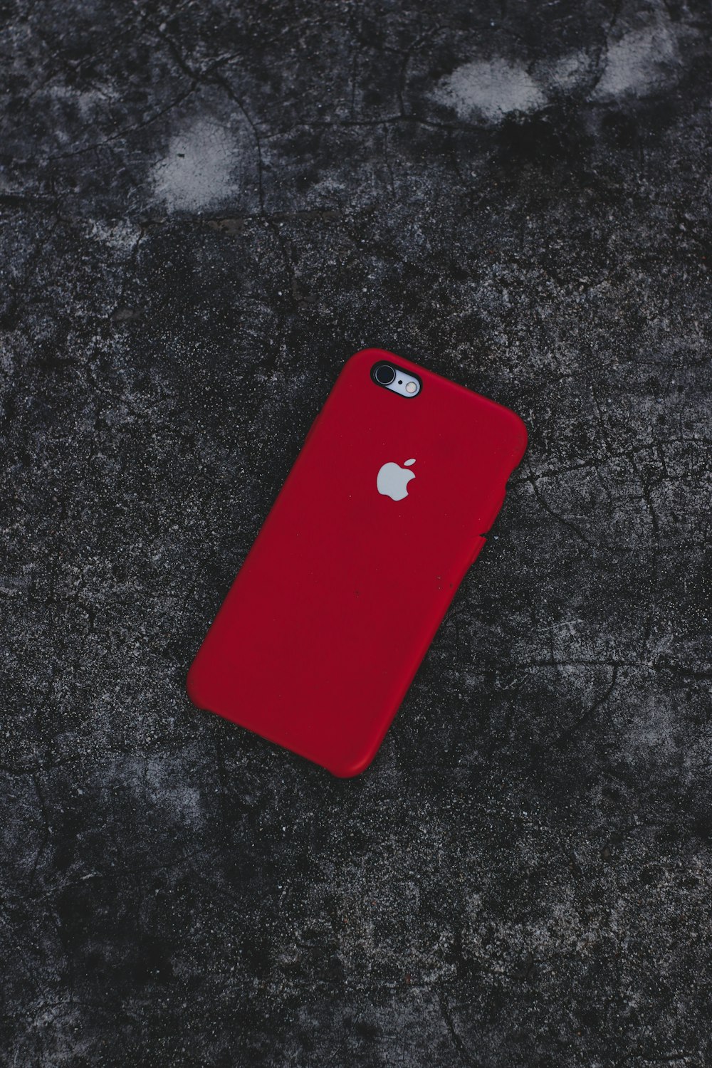 red iphone case on black textile