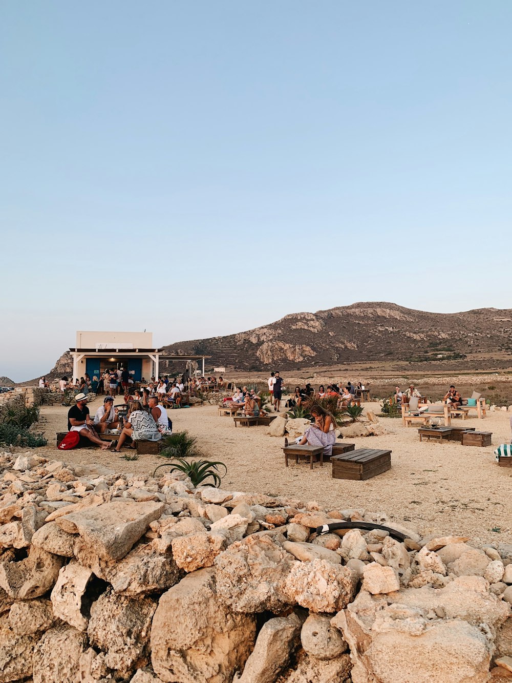 people sitting on brown rock during daytime