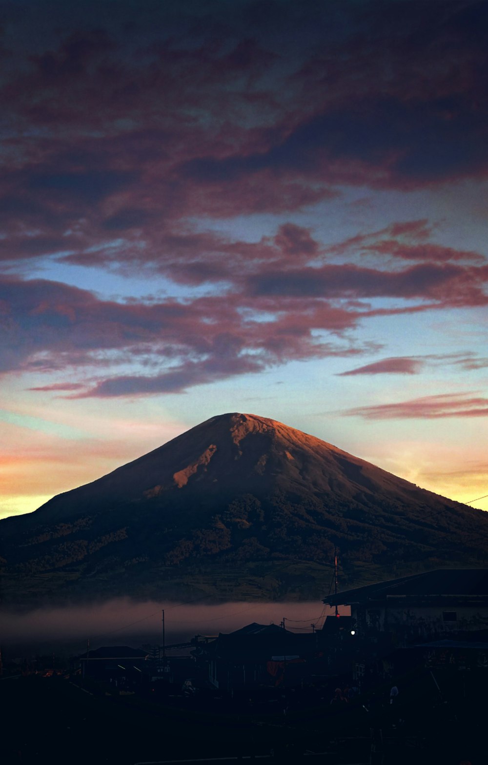 brown and white mountain under cloudy sky during daytime