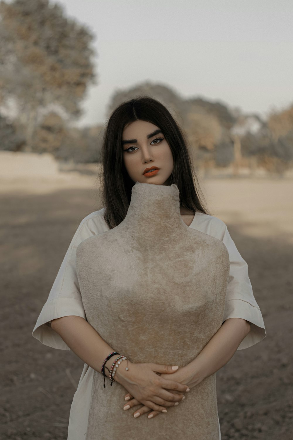 woman in white dress holding white textile