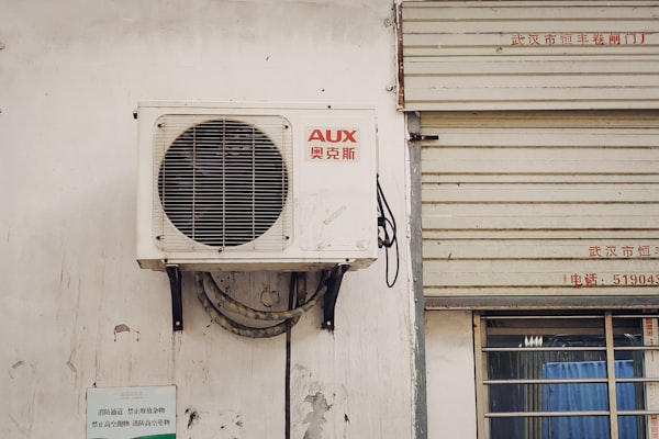 HVAC technician working on AC unit