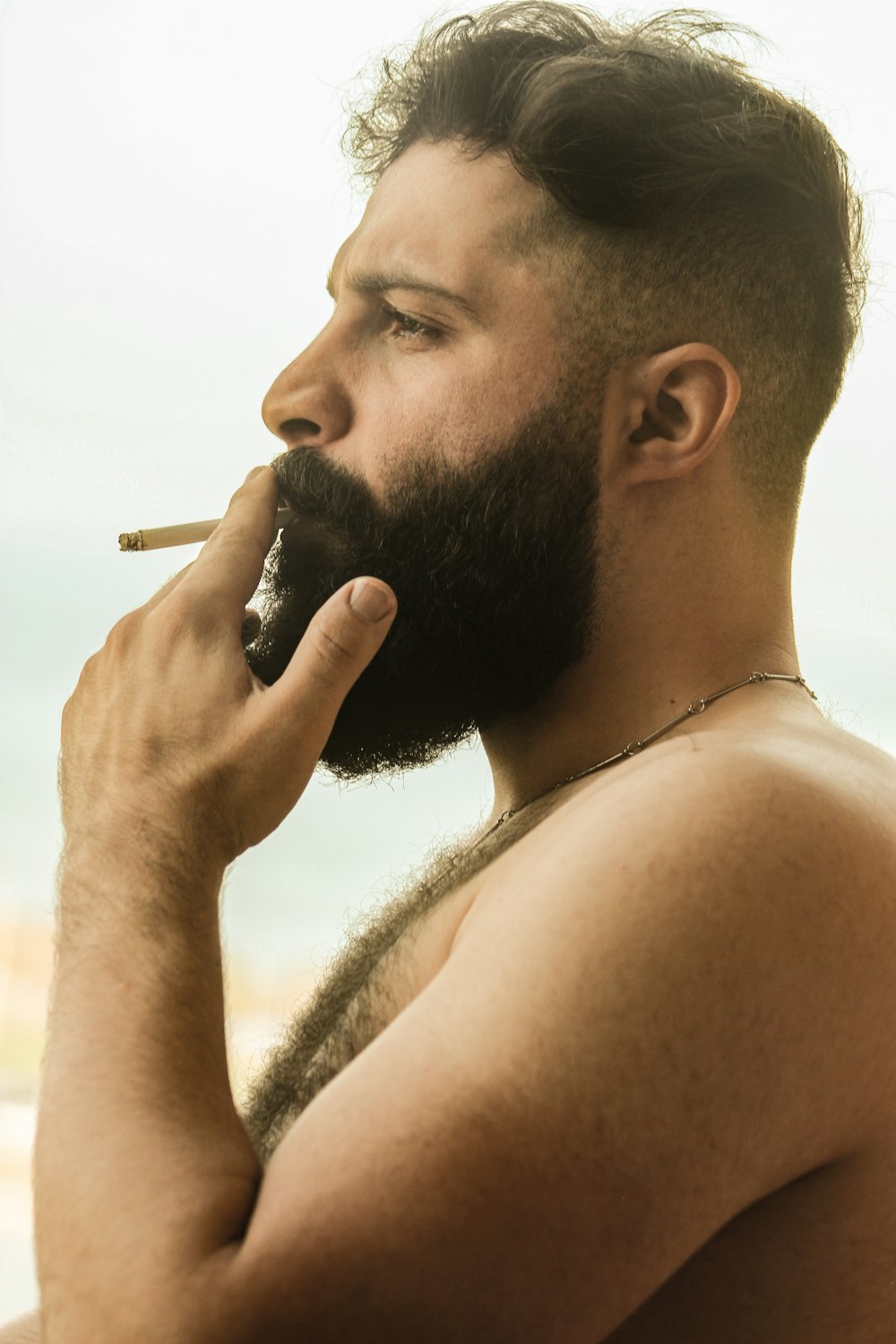 man smoking cigarette during daytime