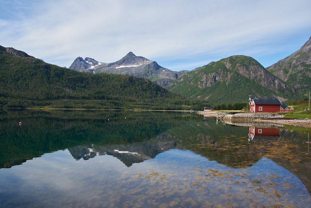 green mountain near body of water during daytime