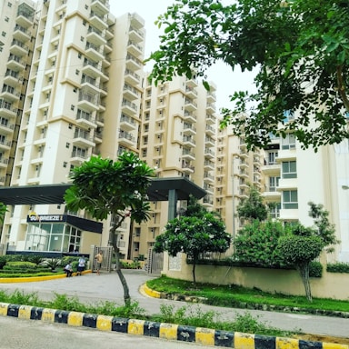 green trees near white concrete building during daytime