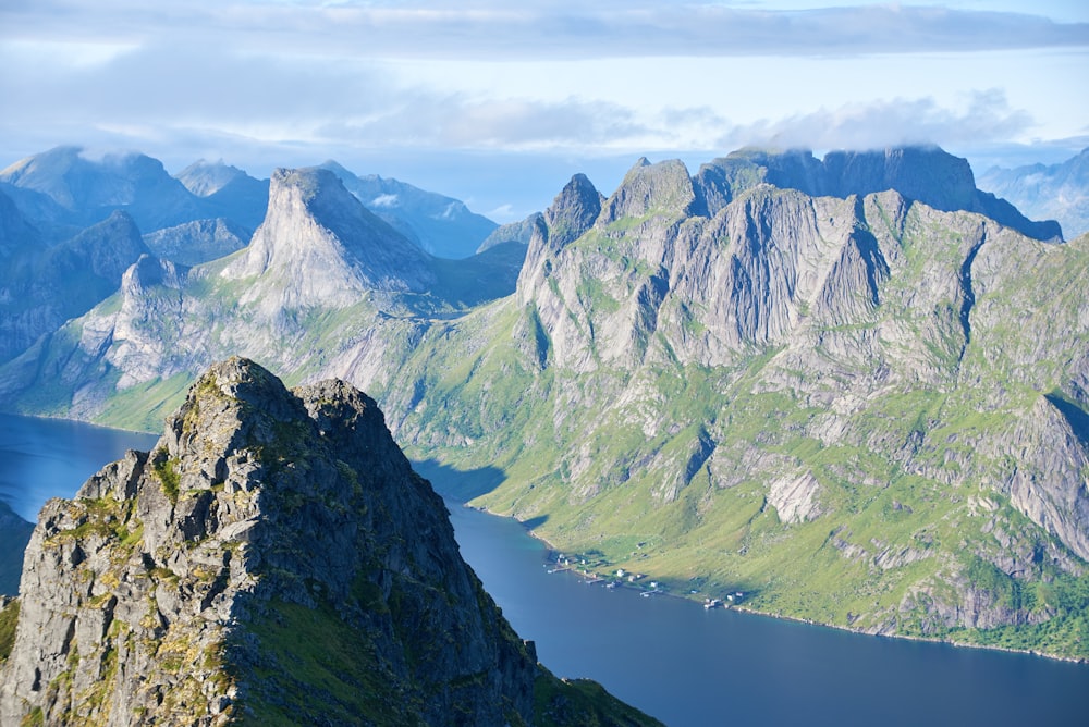 green and white mountains near body of water during daytime