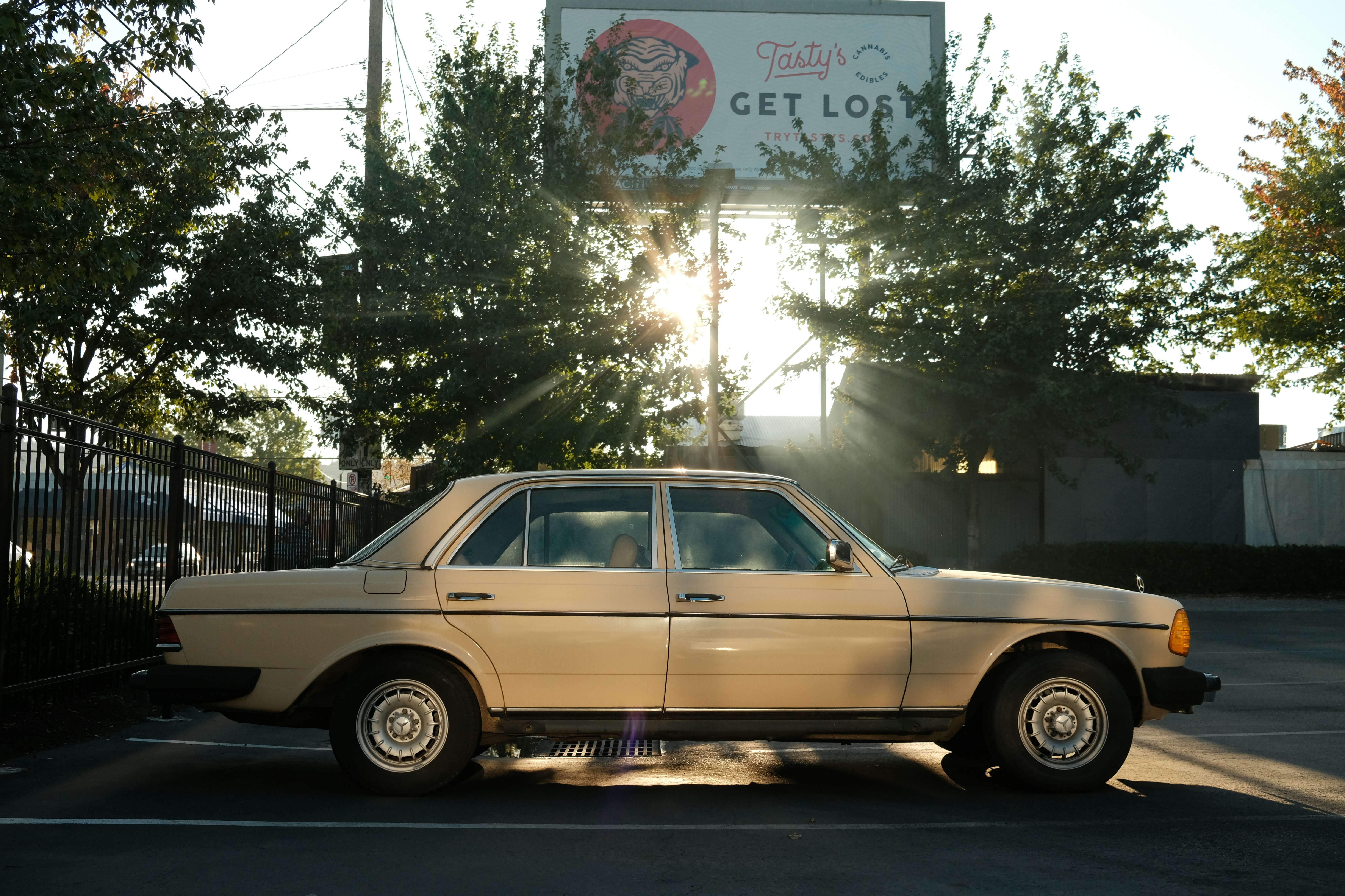 beige station wagon parked on the side of the road