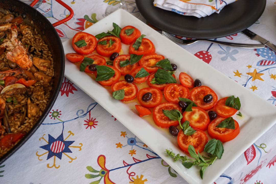 red tomato slices on white ceramic plate,
