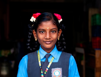 woman in blue and white collared shirt smiling