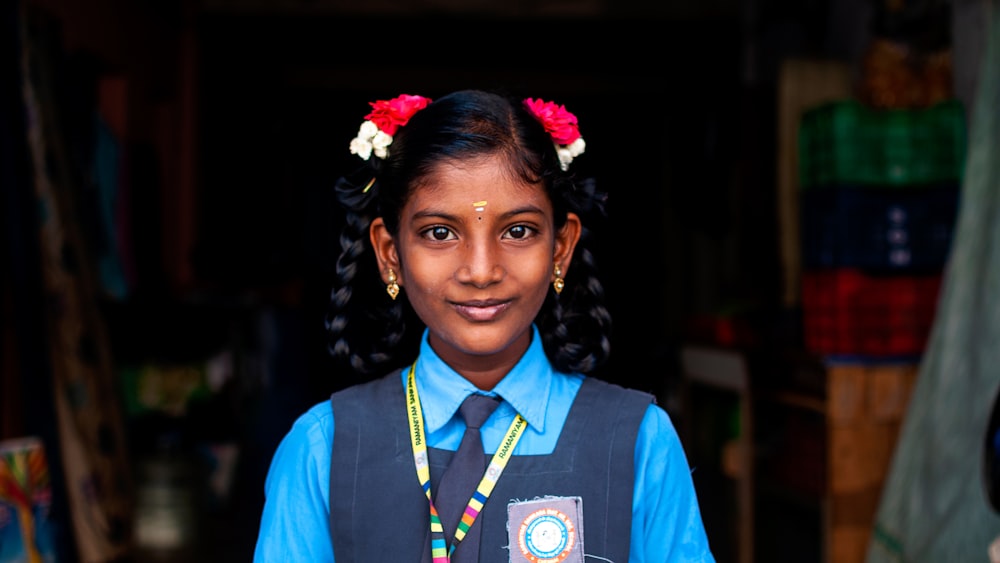 woman in blue and white collared shirt smiling