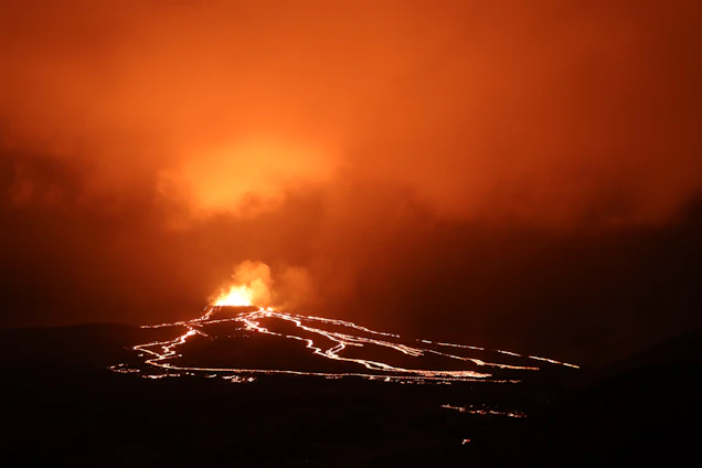 A breathtaking lava flow glowing orange under a dusky Hawaiian sky, surrounded by tropical foliage.
