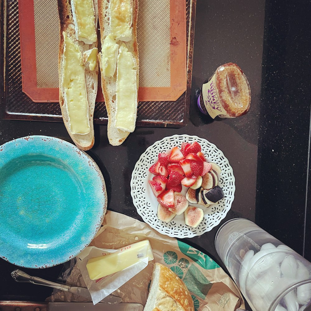 blue ceramic round plate with sliced bread and sliced bread