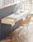 Elegant workspace with minimalist decor, white and beige tones, and spiritual books.