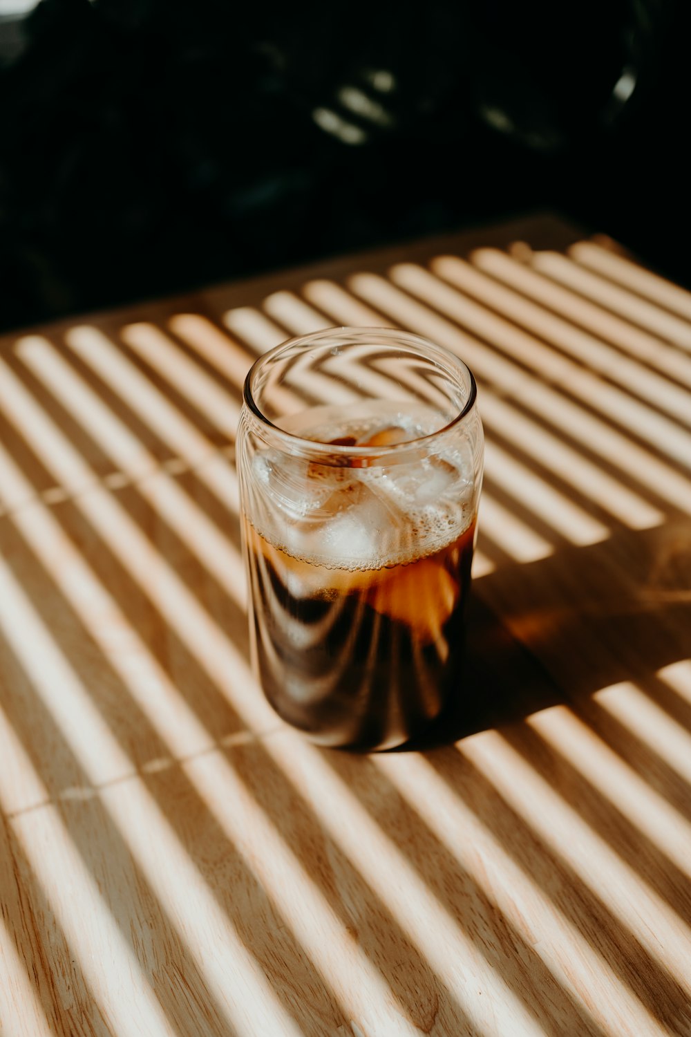 clear drinking glass with brown liquid